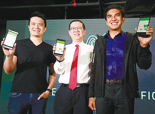 From left: Tan, Lim and Syed Saddiq showing the Razer app after the launch of Razer’s Malaysian headquarters in Bangsar South yesterday. – Masry Che Ani/theSUN