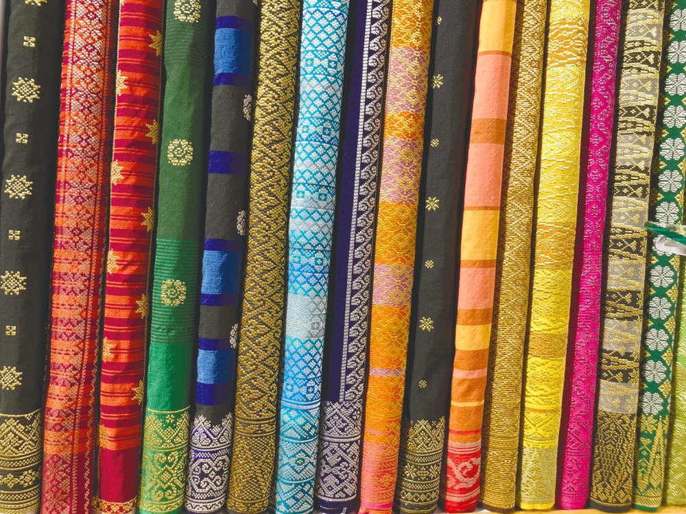 $!Colourful reams of songket fabric.