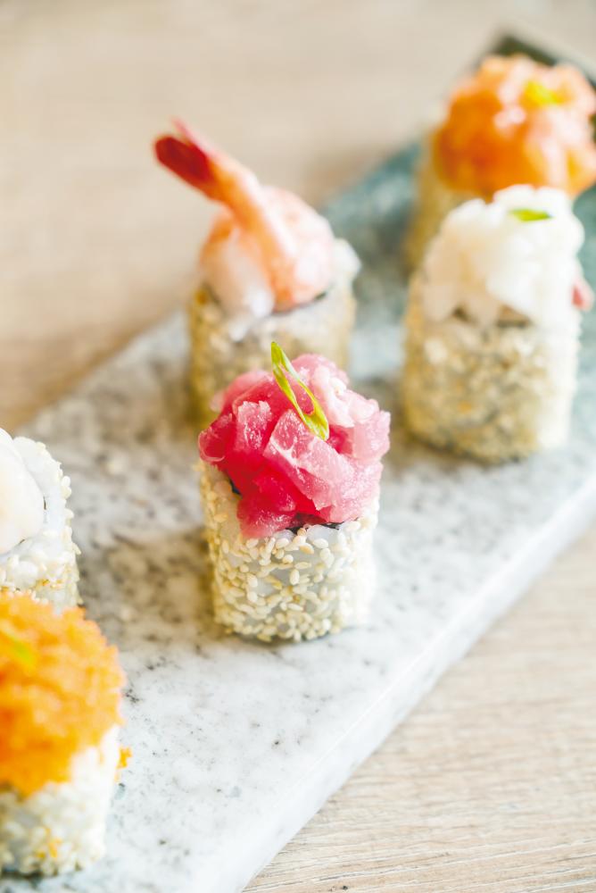 $!Nori is wrapped inside in uramaki sushis. These versions also have added toppings. – 123RF