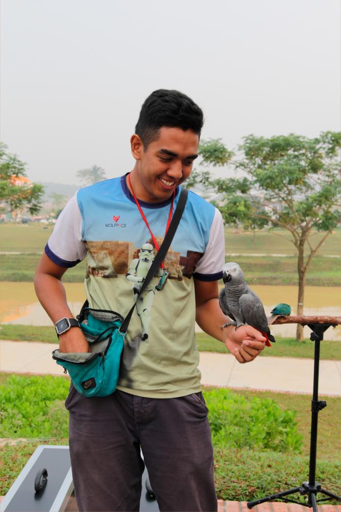 Syimir is a sort of ‘parrot whisperer’. - Picture by Alang Ariff Adib