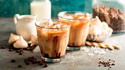 Iced coffee is prepared from brewed hot coffee and serving it over ice. – 123RF