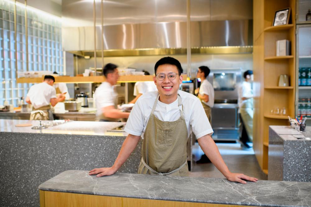 Wong smiling for a picture in front of his kitchen. – PHOTO COURTESY OF JORDAN LYE PHOTOGRAPHY