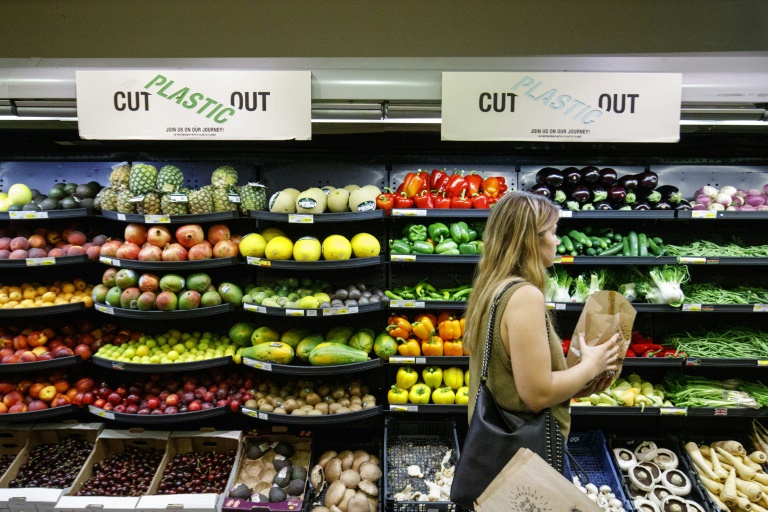 Bowing to pressure from environmentally conscious consumers, big brand shops have begun taking steps to strip their shelves of plastic wrapping. — AFP
