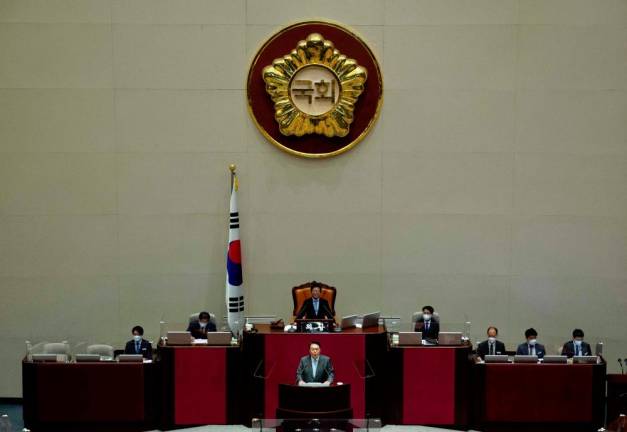 South Korea’s President Yoon Suk-yeol (bottom) speaks on the government’s supplementary revised budget bill at the National Assembly in Seoul. - AFPpix