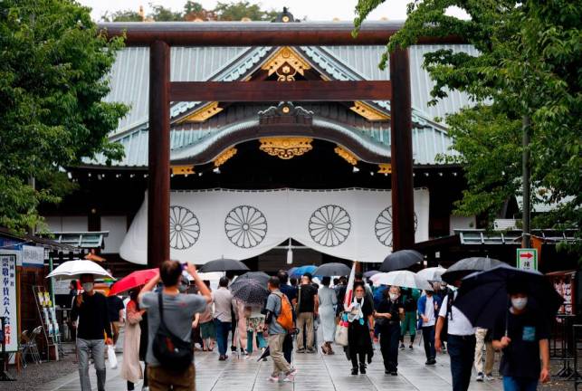 People carry umbrellas as they visit Yasukuni Shrine in Tokyo, Japan/REUTERSPix