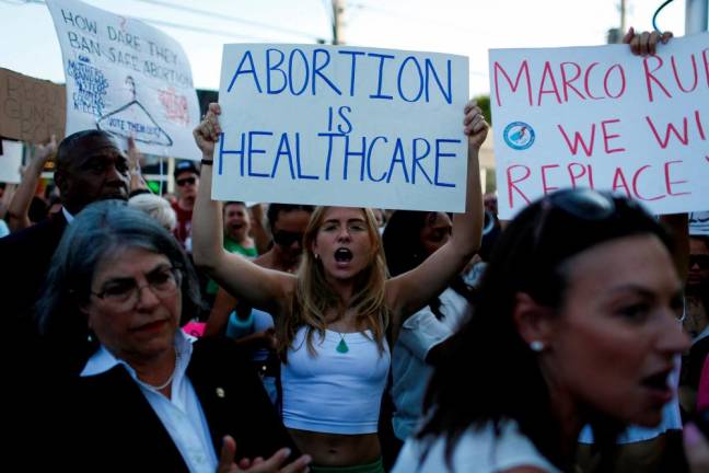An abortion rights protester holds a sign as she demonstrates after the U.S. Supreme Court ruled in the Dobbs v Women’s Health Organization abortion case, overturning the landmark Roe v Wade abortion decision in Miami, Florida/REUTERSPix