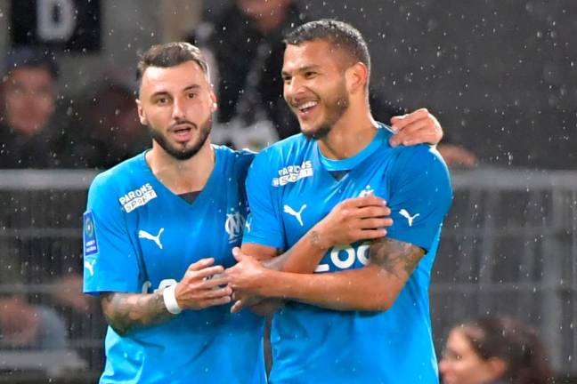 Marseille’s French midfielder Jonathan Clauss (L) celebrates with Marseille’s Colombian forward Luis Suarez scoring his team’s first goal during the French L1 football match between SCO Angers and Olympique Marseille (OM) at The Raymond-Kopa Stadium in Angers, western France on September 30, 2022/AFPPix