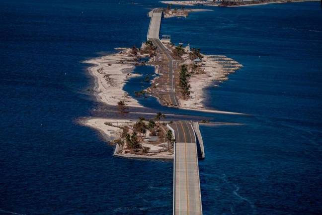 An aerial picture taken on September 30, 2022 shows the collapsed Sanibel Causeway in the aftermath of Hurricane Ian in Sanibel, Florida Forecasters expect Hurricane Ian to cause life-threatening storm surges in the Carolinas on Friday after unleashing devastation in Florida, where it left a yet unknown number of dead in its wake/AFPPix