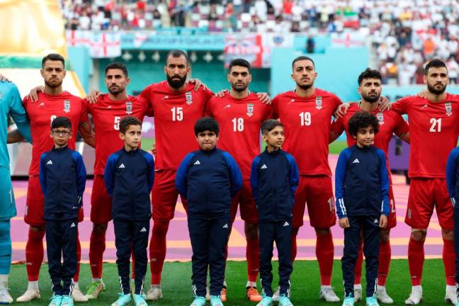 Iran players listen to the national anthem ahead of the Qatar 2022 World Cup Group B football match between England and Iran at the Khalifa International Stadium in Doha on November 21, 2022/AFPPix