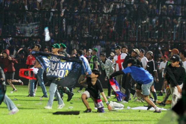 Arema FC supporters enter the field after the team they support lose to Persebaya after football match at Kanjuruhan Stadium, Malang/REUTERSPix