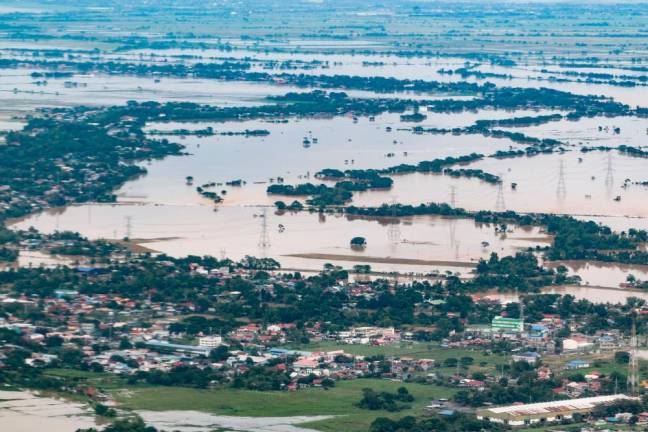 This handout photo taken and released by the Presidential Photographers’ Division on September 26, 2022 shows an aerial view of a flooded area in Central Luzon in the aftermath of Typhoon Noru/AFPPix