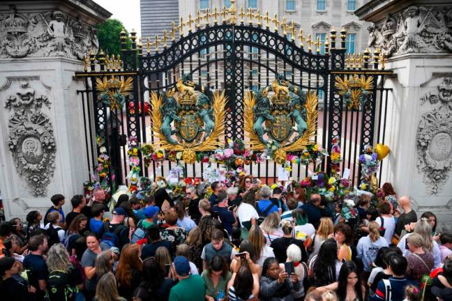 A general view of floral tributes on the gates at Buckingham Palace in London on September 11, 2022/AFPPix
