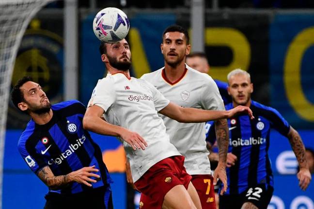 Inter Milan’s Turkish midfielder Hakan Calhanoglu (L) and AS Roma’s Italian midfielder Bryan Cristante (2ndL) go for the ball during the Italian Serie A football match between Inter and AS Roma/AFPPix