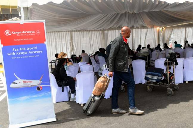 A passenger approaches a Kenya Airways help desk thats assisting travelling passengers to re-book flights and hotels, on the second day of a strike by pilots organised by Kenya Airline Pilots Association (KALPA), at the Jomo Kenyatta International airport in Nairobi/AFPPix