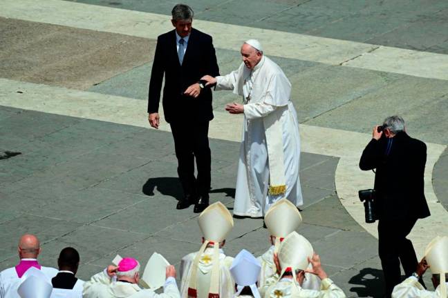 Pope Francis (C) is helped as he leaves after a canonisation mass at St. Peter’s Square in The Vatican on May 15, 2022 creating 10 saints including India’s Devasahayam, French hermit Charles de Foucauld and Dutch theologian Titus Brandsma. - AFPpix