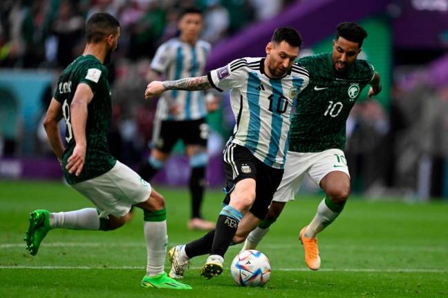 Saudi Arabia’s midfielder #10 Salem Al-Dawsari (R) fights for the ball with Argentina’s forward #10 Lionel Messi during the Qatar 2022 World Cup Group C football match between Argentina and Saudi Arabia at the Lusail Stadium in Lusail, north of Doha on November 22, 2022. AFPPIX