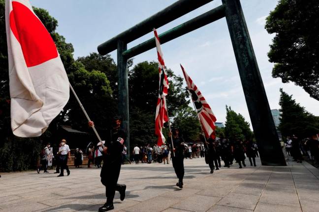 Members of a right-wing group visit Yasukuni Shrine on the 77th anniversary of Japan's surrender in World War Two, in Tokyo, Japan August 15, 2022. - REUTERSPIX