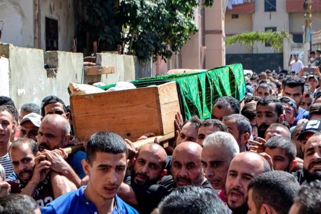 Mourners march with the body of one of the victims who drowned in the shipwreck of a migrant boat that sank off the Syrian coast, during his funeral after the return of his body in Lebanon’s northern port city of Tripoli/AFPPix
