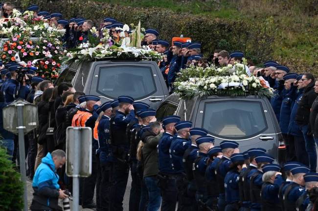Belgian police officers form an honorary guard as they stand in attention during the funeral ceremony of police officer Thomas Monjoie, in Waremme, on November 18, 2022./AFPPix