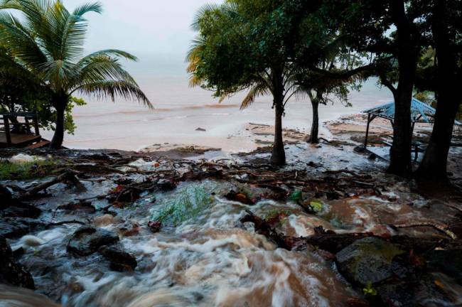 A photo shows mud and debris on a beach in Basse Terre, after the Storm Fiona hit the French Caribbean island of Guadeloupe/AFPPix