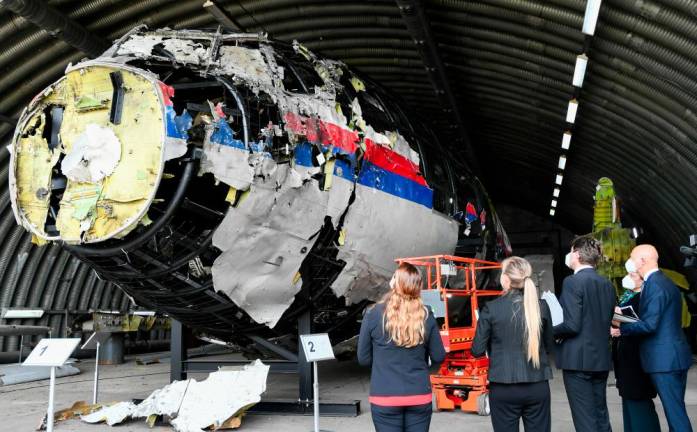 Presiding Judge Hendrik Steenhuis inspects the reconstruction of the MH17 wreckage, as part of the murder trial ahead of the beginning of a critical stage, in Reijen, Netherlands, May 26, 2021. - REUTERSPIX