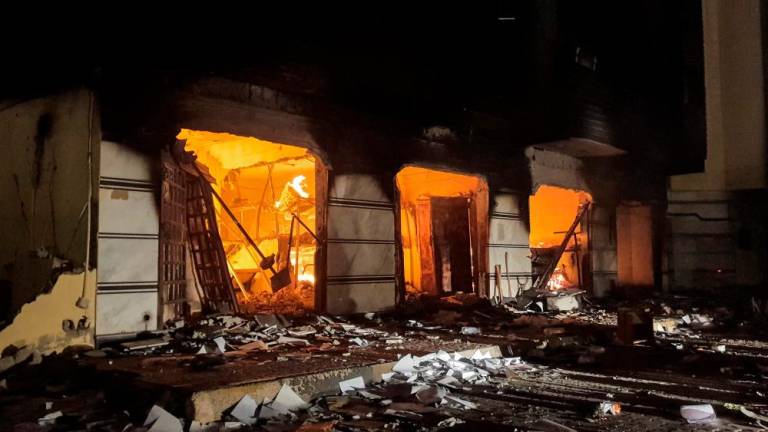 This picture taken early on July 2, 2022 shows a fire inside the building used by Libya’s Tobruk-based parliament building in the country’s east, lit up by protesters who broke inside while demonstrating against deteriorating living conditions and political deadlock. AFPPIX