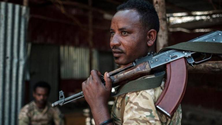 A member of the Amhara Special Forces looks on as he holds his rifle at the 5th Battalion of the Northern Command of the Ethiopian Army in Dansha, Ethiopia, on November 25, 2020 - AFPPIX