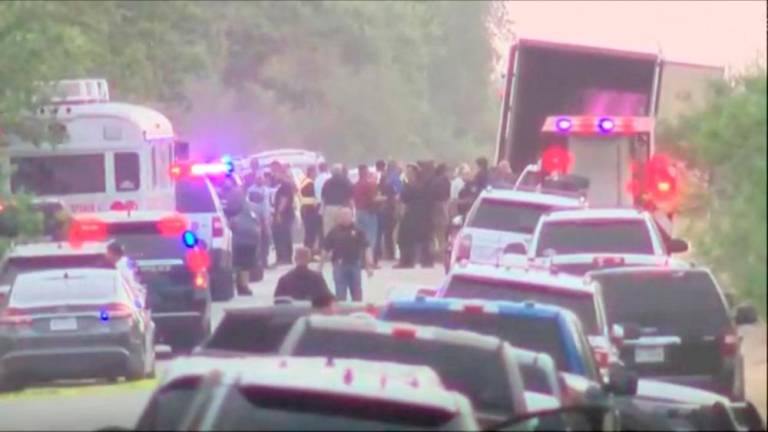 Law enforcement officers work at the scene where dozens of people were found dead inside a trailer truck in San Antonio, Texas, U.S. June 27, 2022 in a still image from video. ABC AFFILIATE KSAT via REUTERSPIX