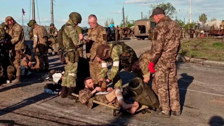 This screen grab obtained from a handout video released by the Russian Defence Ministry on May 17, 2022, shows Ukrainian service members as they are searched by pro-Russian military personnel after leaving the besieged Azovstal steel plant in Ukraine’s port city of Mariupol. AFPPIX