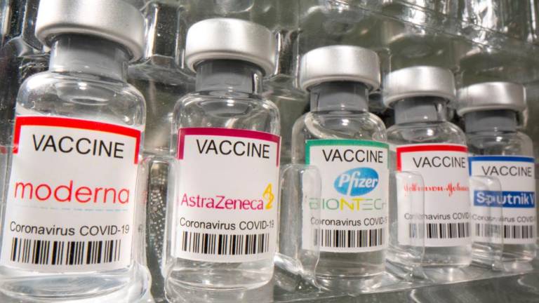 FILE PHOTO: Vials labelled Moderna, AstraZeneca, Pfizer - Biontech, Johnson&amp;Johnson, Sputnik V coronavirus disease (COVID-19) vaccine are seen in this illustration picture taken May 2, 2021. REUTERSPIX