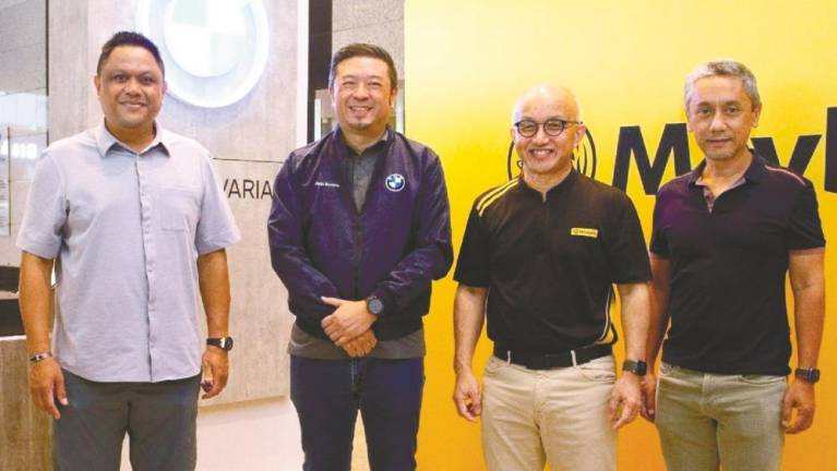 From left: Maybank chief sustainability officer Shahril Azuar Jimin, Sime Darby Auto Bavaria managing director Thim Juan Vi, Chong and Etiqa Insurance and Takaful Group CEO Kamaludin Ahmad at the Maybank EV driving experience event.
