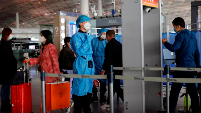 File photo: Medical staff members check the temperature of people as they enter at Capital Airport, following an outbreak of the coronavirus disease (Covid-19), in Beijing, China, November 5, 2020. REUTERSpix