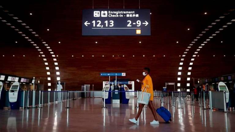 In this file photo, a woman makes her way in the departures area of the Terminal 2E at Charles-de-Gaulle airport amid the Covid-19 outbreak in Roissy, near Paris, France. - REUTERSPIX