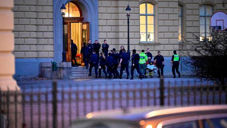 FILE PHOTO: Police officers and ambulance personnel attend at the scene of a crime by a school in Malmo, Sweden March 21, 2022.