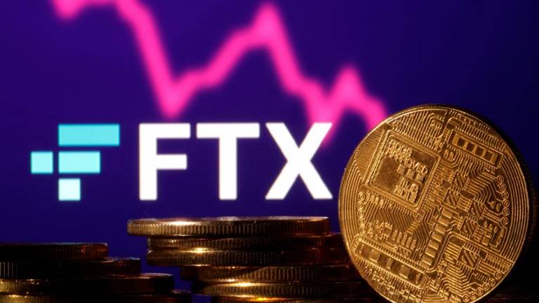 Representations of cryptocurrencies are seen in front of displayed FTX logo and graph in this illustration. – Reuterspic