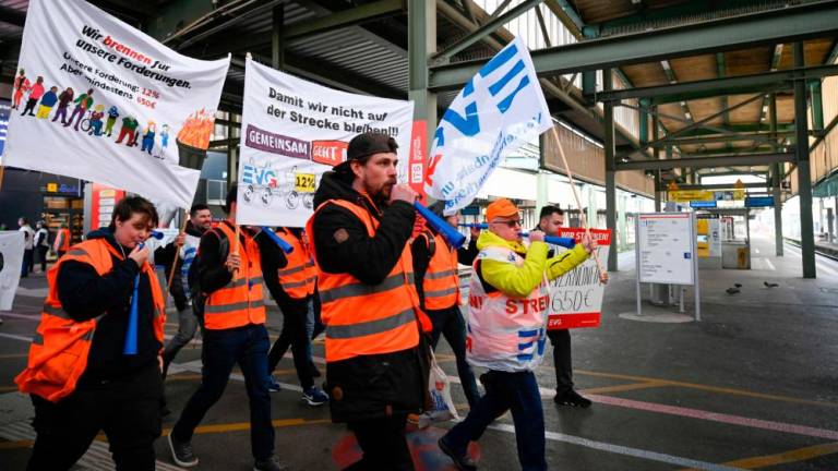 Members of the railway union EVG protest in the main railway station in Stuttgart, southern Germany, during a warning strike on March 27, 2023. AFPPIX