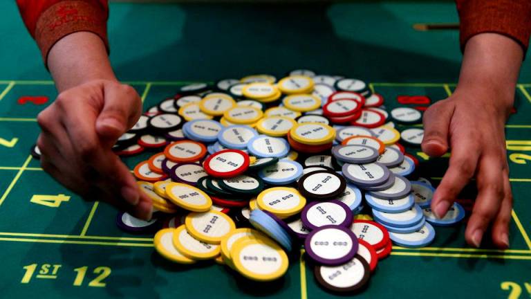 A casino dealer collects chips at a roulette table in Pasay city, Metro Manila, Philippines, March 27, 2015. REUTERSPIX