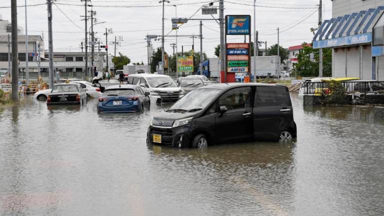 Vehicles submerged under water following heavy rain brought about by Typhoon Mawar are pictured in Toyokawa, Aichi Prefecture, central Japan in this photo taken by Kyodo on June 3, 2023. REUTERSPIX