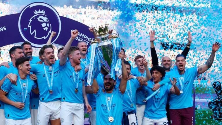 May 21, 2023 Manchester City’s Ilkay Gundogan lifts the trophy as he celebrates with teammates after winning the Premier League. REUTERSPIX