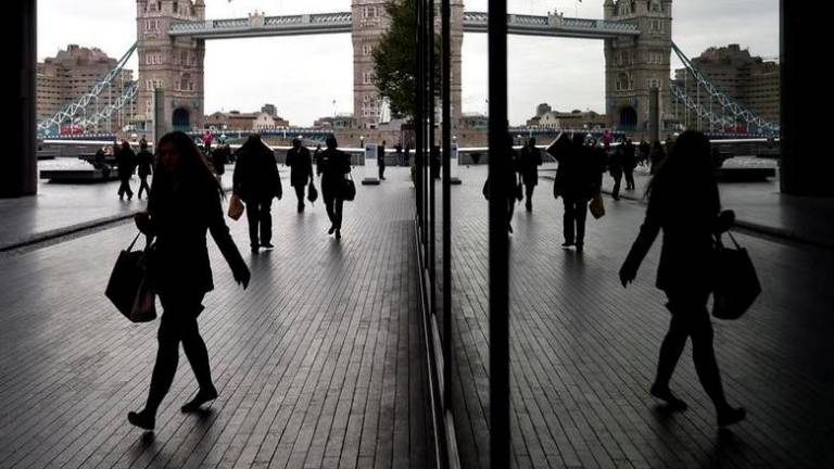 Workers walk through the More London business district with Tower Bridge seen behind in London, Britain, November 11, 2015. REUTERSPIX