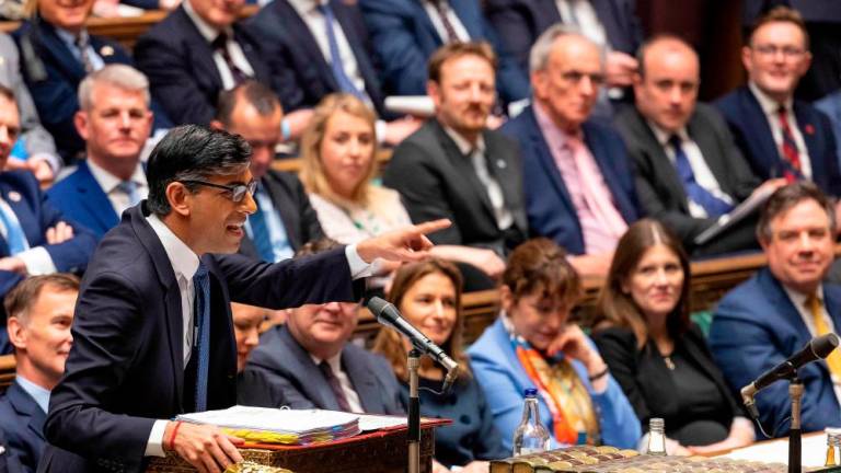 A handout photograph released by the UK Parliament shows Britain's Prime Minister Rishi Sunak standing at the despatch box and speaking during the weekly session of Prime Minister's Questions (PMQs) at the House of Commons, in London, on March 22, 2023. AFPPIX