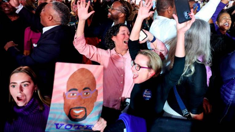 Supporters cheer as the George Senate runoff election is called for Sen. Raphael Warnock (D-GA) at the Warnock election right watch party at the Marriott Marquis/AFPPIX