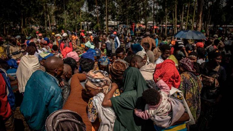 Internal displaced paople, fleeing the recent clashes between M23 rebels and Congolese soldiers, gather in Kanyarushinya north of Goma on May 27, 2022. AFPPIX