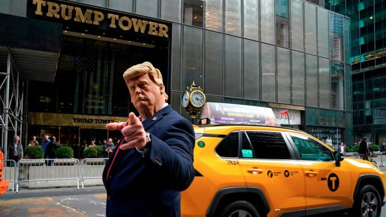 Former US President Donald Trump's impersonator Neil Greenfield gestures outside Trump Tower in New York City on March 22, 2023. AFPPIX