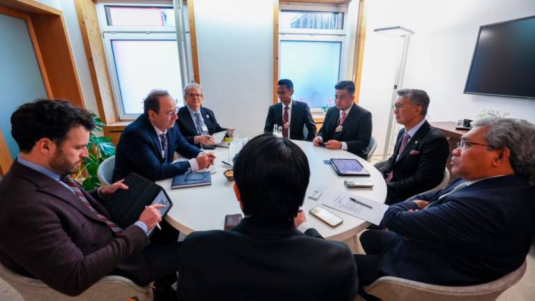 Tengku Zafrul and Esfarjani (second, left) at their meeting in Davos on Wednesfay. – Bernamapic