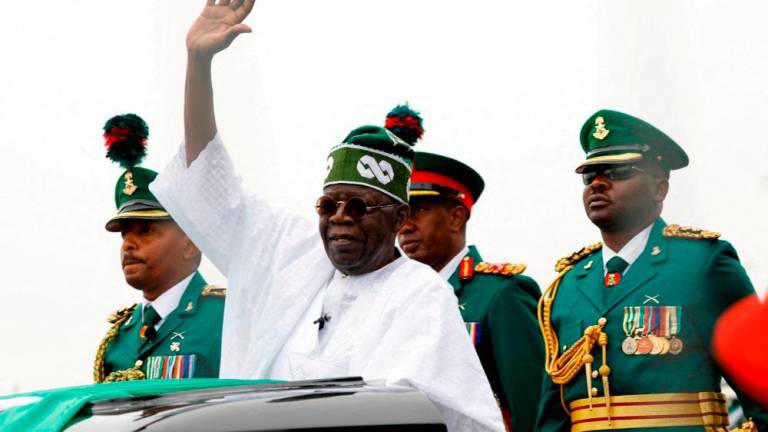Nigerian President Bola Tinubu waves at a crowd, during his swearing-in ceremony in Abuja, Nigeria May 29, 2023. REUTERSPIX