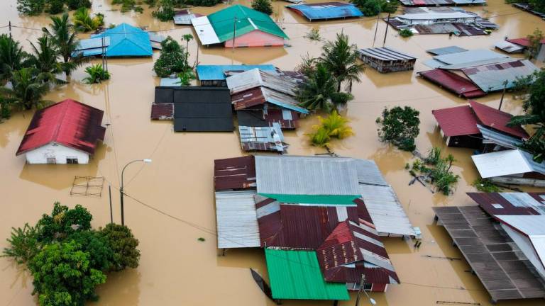 An aerial view shows flooded houses in Yong Peng, Malaysia’s Johor state, on March 4, 2023. BERNAMAPIX