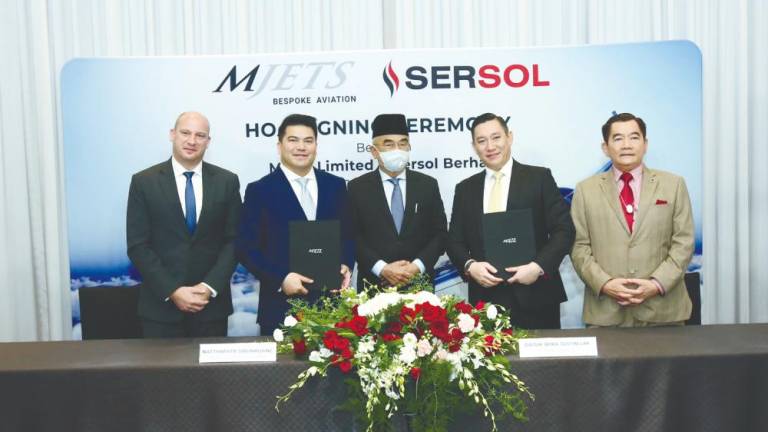 From left: MJets chief commercial officer Philippe Leysen, Natthapatr Sibunruang, Mohd Ali, Lim and Sersol Bhd group managing director Datuk Seri Tan Choon Hwa at the signing ceremony