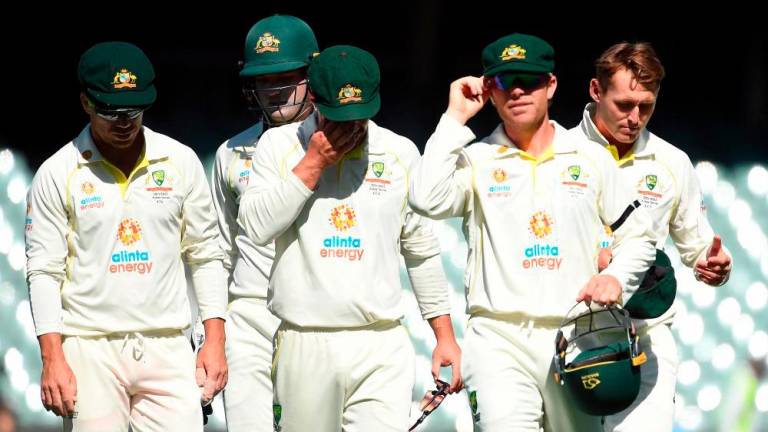 Cricket - Ashes - Second Test - Australia v England - Adelaide Oval, Adelaide, Australia - December 20, 2021, Australia players walk off the pitch for lunch. - REUTERSPIX