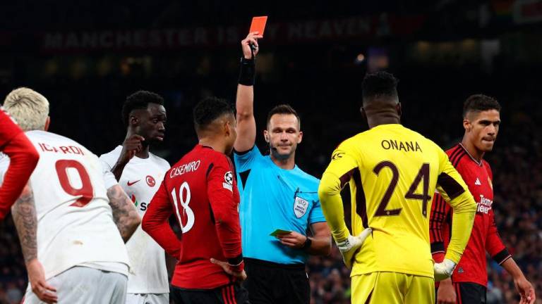 Referee Ivan Kruzliak shows a red card to Casemiro during the UEFA Champions league group A football match between Manchester United and Galatasaray at Old Trafford stadium in Manchester, north west England, on October 3, 2023. AFPPIX